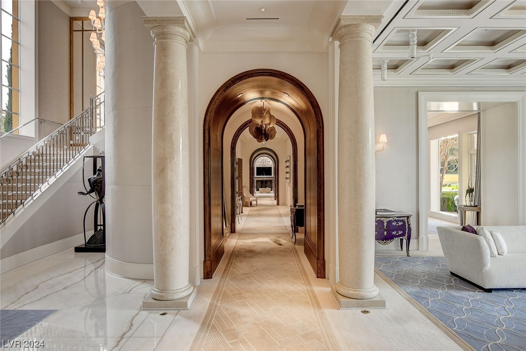 Off the Entry, the main hallway with custom wood arches and marble columns