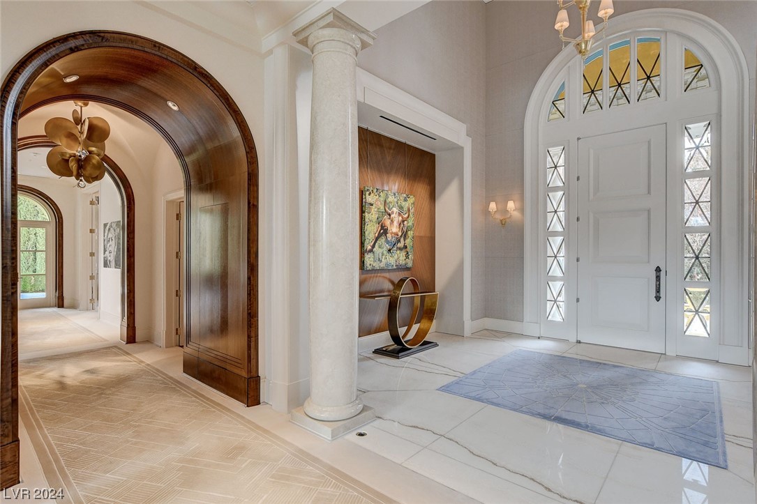 Main entry with marble floors, marble columns and silk carpeting.  To the left hallways wood archways.