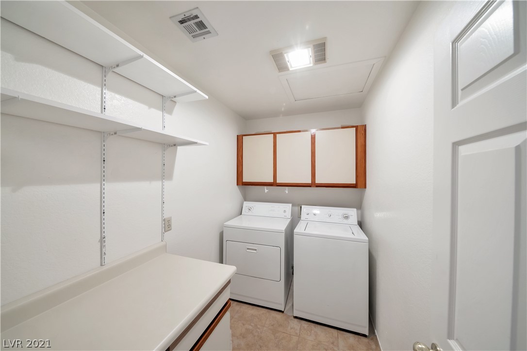 Photo #12: The laundry room has lots of space, cabinets, shel