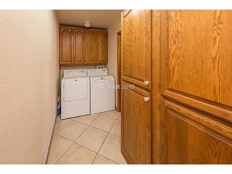 Laundry Rm/Area. Great storage in the laundry area with custom built cabinets, tile floors & lots of light.