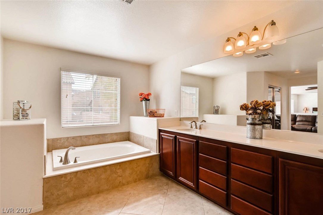 Master bath with separate soaking tub; plenty of drawers!!! Immense counter space and great lighting.  Spread out and enjoy your Master Retreat!