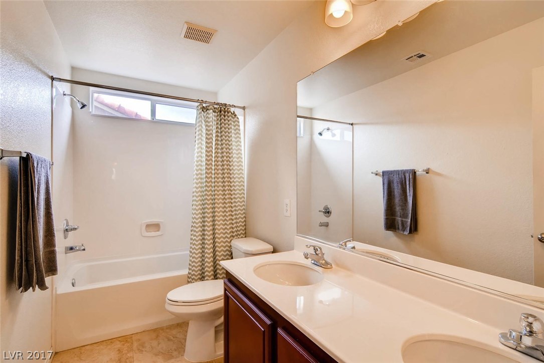 Upstairs full bath with room for multiple people at a time.  More lustrous cabinetry and solid surface counters.  There are no tile counters in this house!!  The family will love this house!