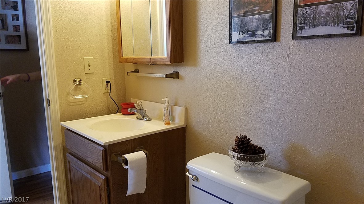 Half-bathrooms off hallway between living room and garage.  Easy access to kitchen.  It also houses the laundry area at one end!  Very convenient