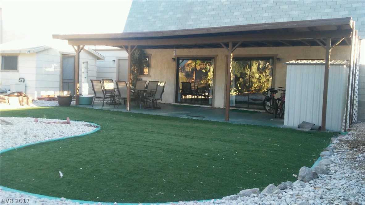 Synthetic grass and full covered patio are just part of this extra deep back yard.  Notice the casita on the left -- it's where the husband goes to watch Football! YAY Team!