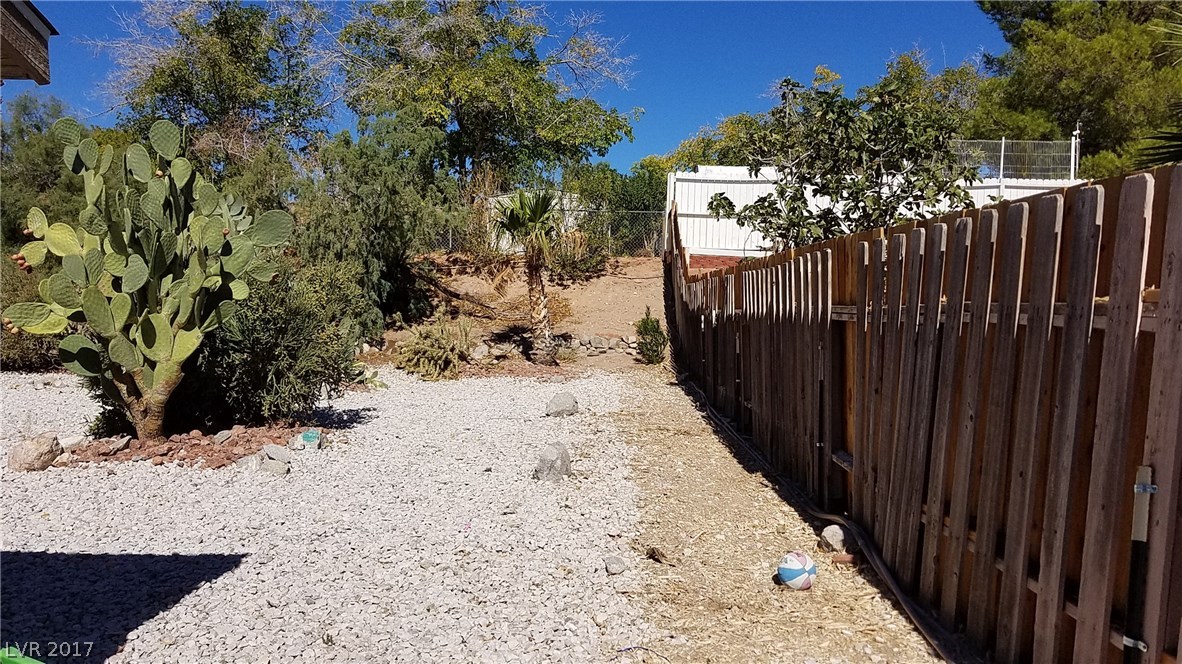 Tucson is calling!! Native plants, low maintenance, easy outdoor living just like in Tuscon!  Yard stretches back to the cyclone fence at the top.  So many possibilities!!