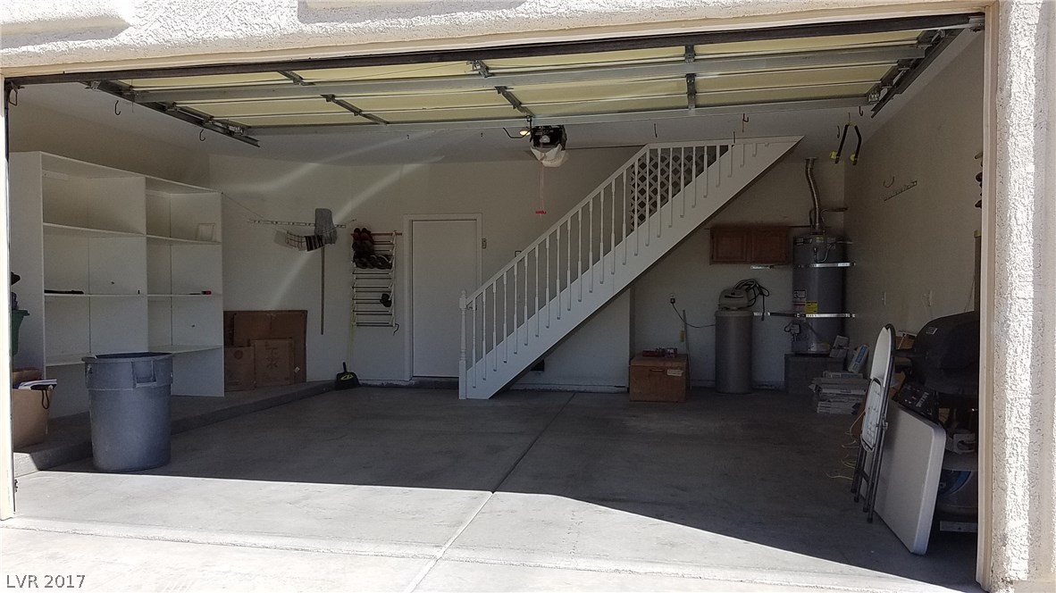 The two-car garage is extra wide, extra deep and extra tall.  The stairs go to the office/loft.  Water softener is included.  Shelves on left can be fitted with cupboard doors from Home Depot.  Swamp cooler on right.