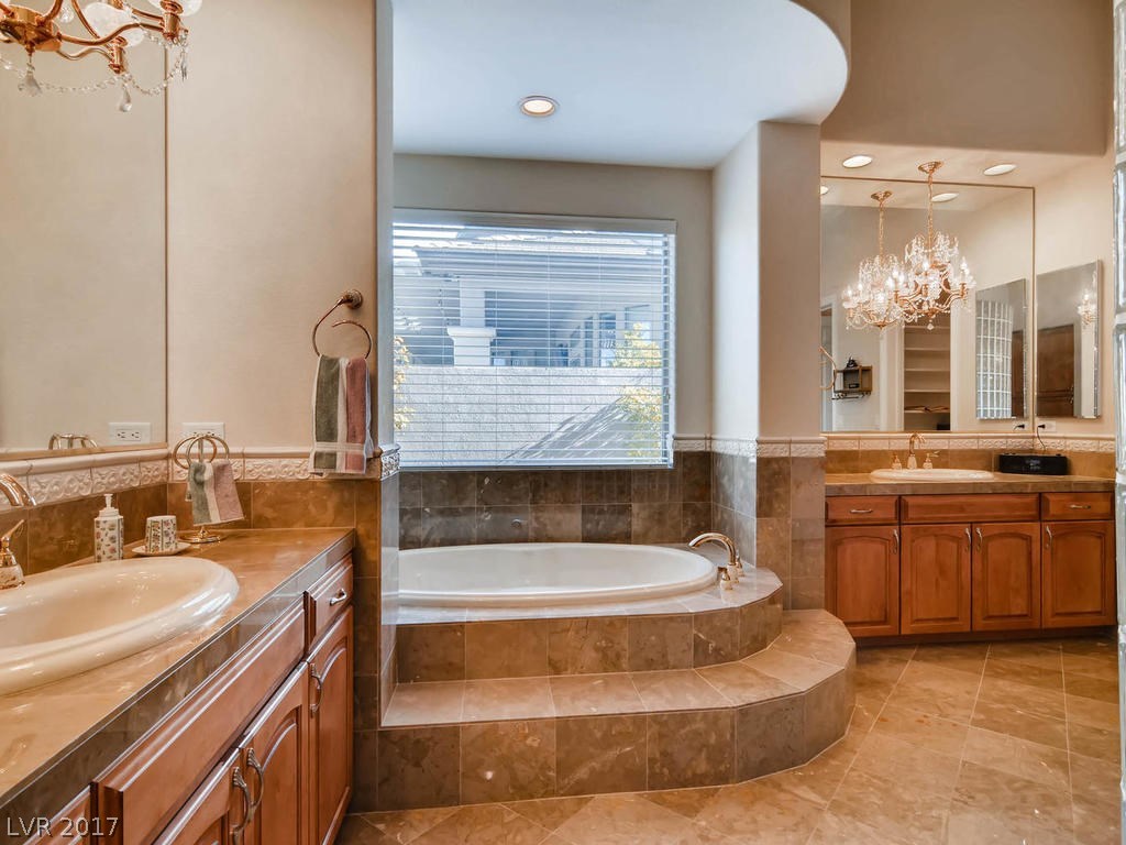 His and her sinks; large soaking tubs, beautiful floors & surrounds.  Jewelry chandeliers to please the ladies!