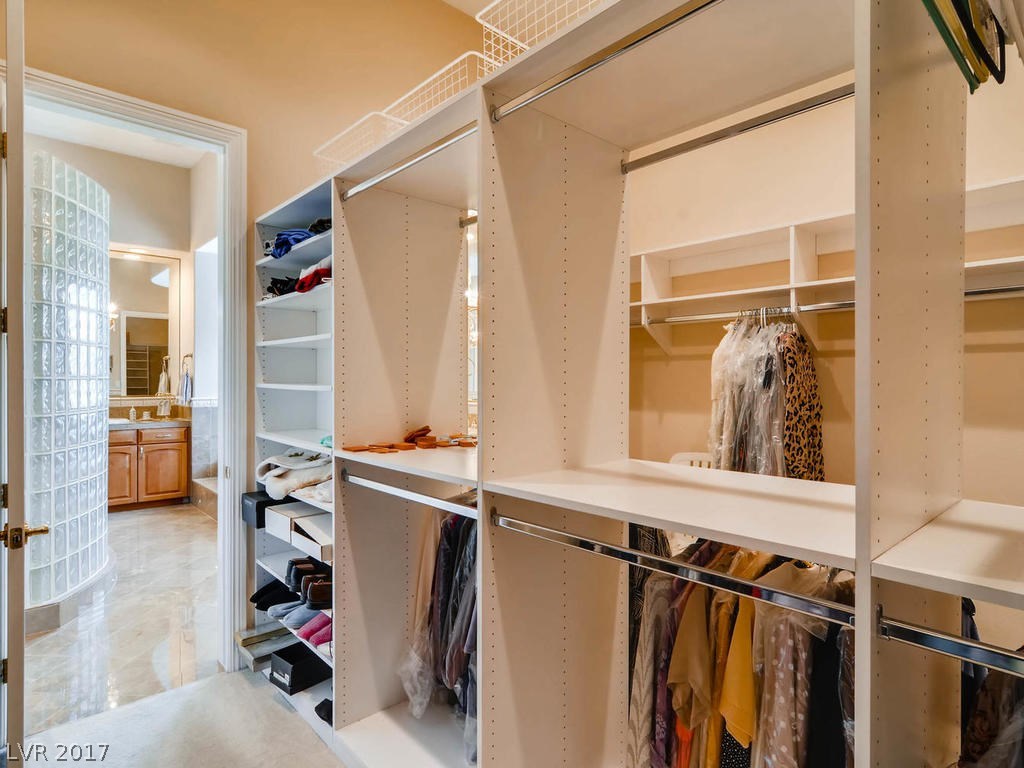 Master closet has 2 doors, one for each side.  Shelves in middle are open for easy access from both sides, with baskets up above for more storage.