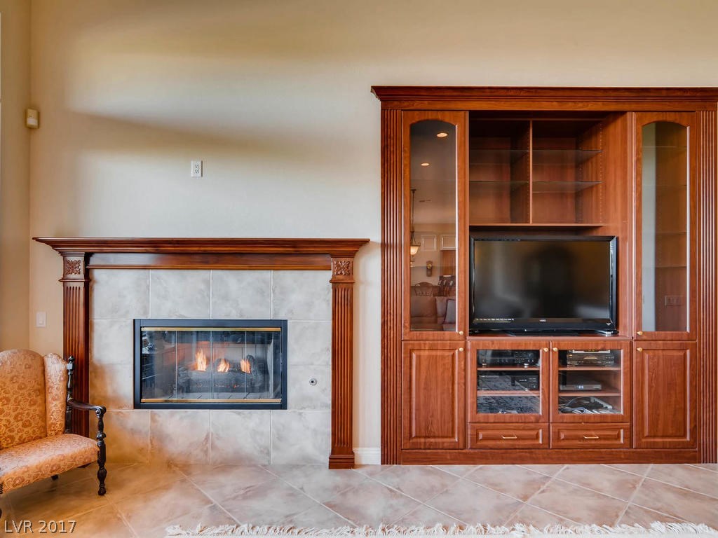 Gas fireplace for the cooler evenings.  Custom inserted cabinetry to match the fireplace surround.