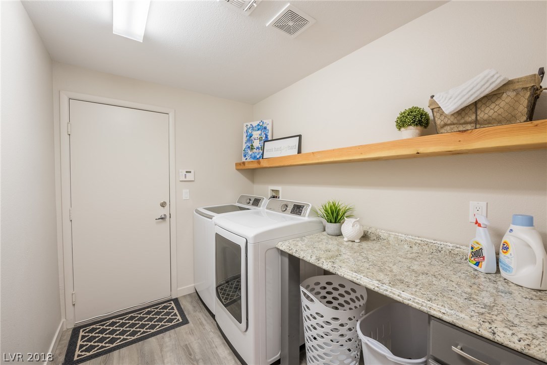 You will love this large laundry room which offers top-of-the-line washer & gas dryer, a perfect customer counter top for all your laundry folding needs, a custom wood shelf for additional storage space; a customized cabinet designed for your laundry baskets with an extra storage cabinet & drawer.