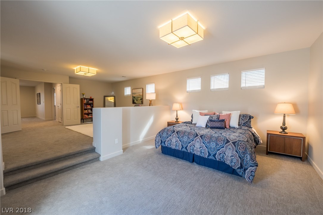 This master bedroom upstairs is incredible, and has the feel of a custom home of pure luxury.  Enjoy the custom lighting along with all the natural light from all the windows & sliding glass door.
