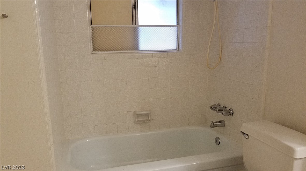 Hall bath has a tub and shower, with a window to the covered patio.