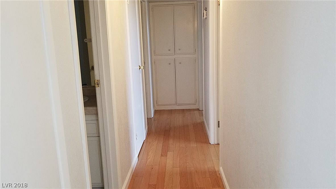 The hallway ends in a double linen closet!  There are also two coat closets along the left wall, not in the picture.