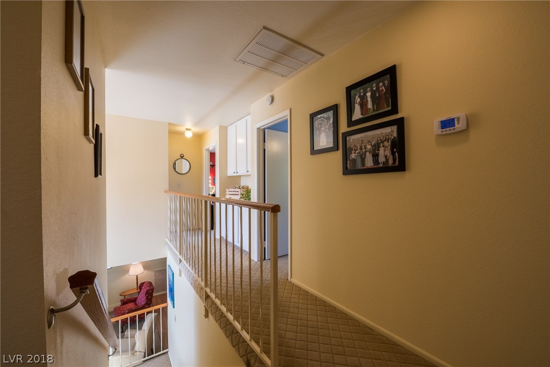 Large hallway upstairs has upgraded stair railing to give you a more open feel, plus additional built-in cabinetry for extra storage space.