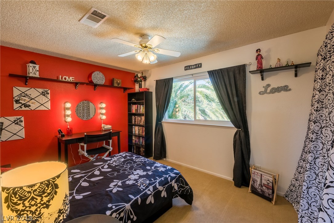 Large secondary bedroom located upstairs away from master, offers ceiling fan + large window for natural light.  (sorry guys, vanity lights on wall do not stay - decor item only!)