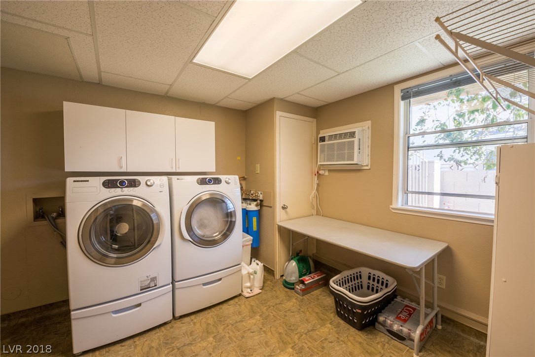 One of the best laundry rooms throughout this community!!!  Large laundry room downstairs is a custom feature this home offers, as the sellers legally added this room on to provide additional space for their use & yours!