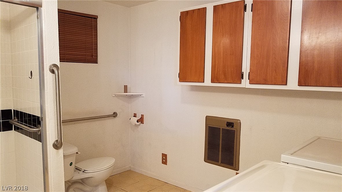 Master bath with large shower, lots of cabinets and the laundry area (handy!)