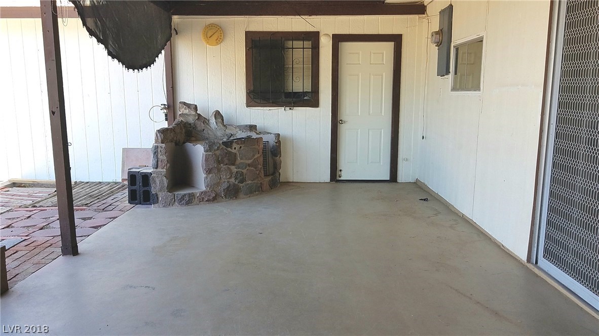 View of one of the doors into the garage.  There is another door at the end of the covered parking in front.  3 ways in or out of this garage!