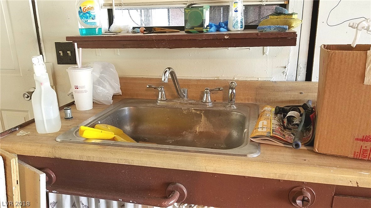Wash-up sink in the garage, with a window overlooking the covered patio.