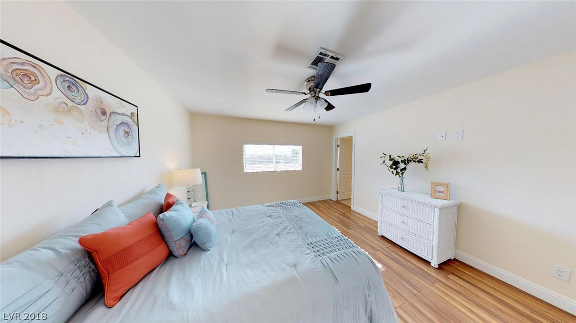 2nd Master Bedroom offer a window with natural light, ceiling fan with light, cable/electrical for wall-mounted television, and laminate wood floors.