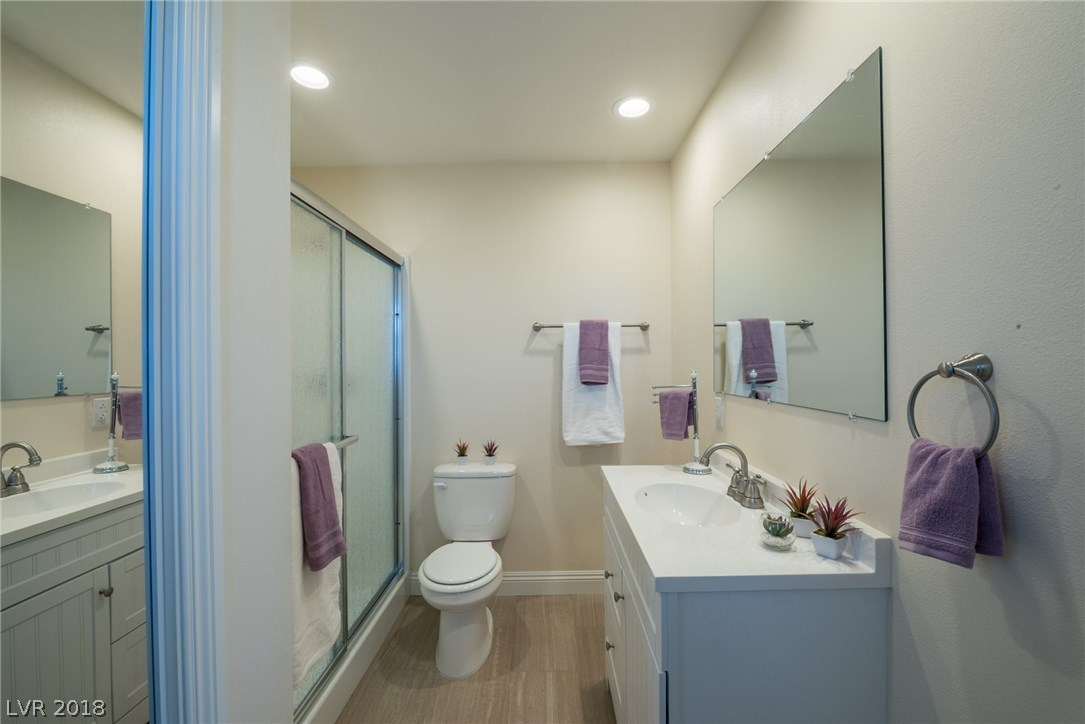 2nd Master On-Suite Bathroom offers a custom vanity, tile floors, closet, and stand-up shower.