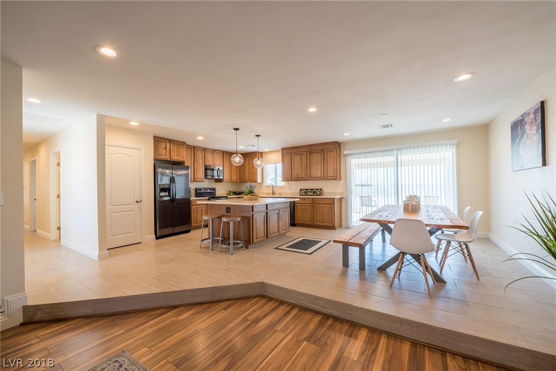 Gorgeous great room floor plan offers custom kitchen with large island, pantry & dining area.