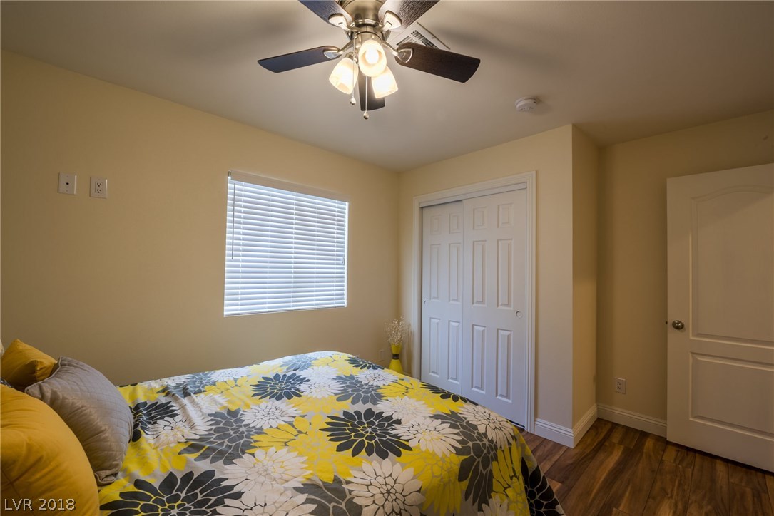 3rd bedroom offers natural light, closet, ceiling fan, laminate wood floors & cable/electrical for tv mount.