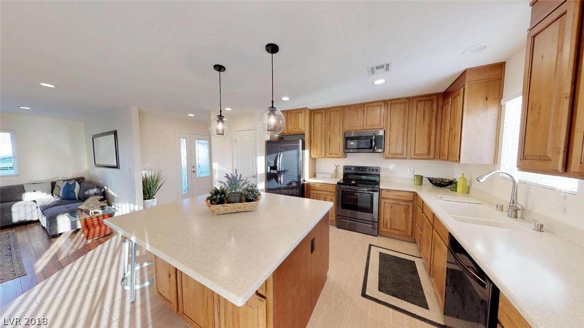 You will love this extra large island for all of your cooking & entertaining needs.  Extra cabinet storage is accessible on both sides of the island.  Custom corian countertops.