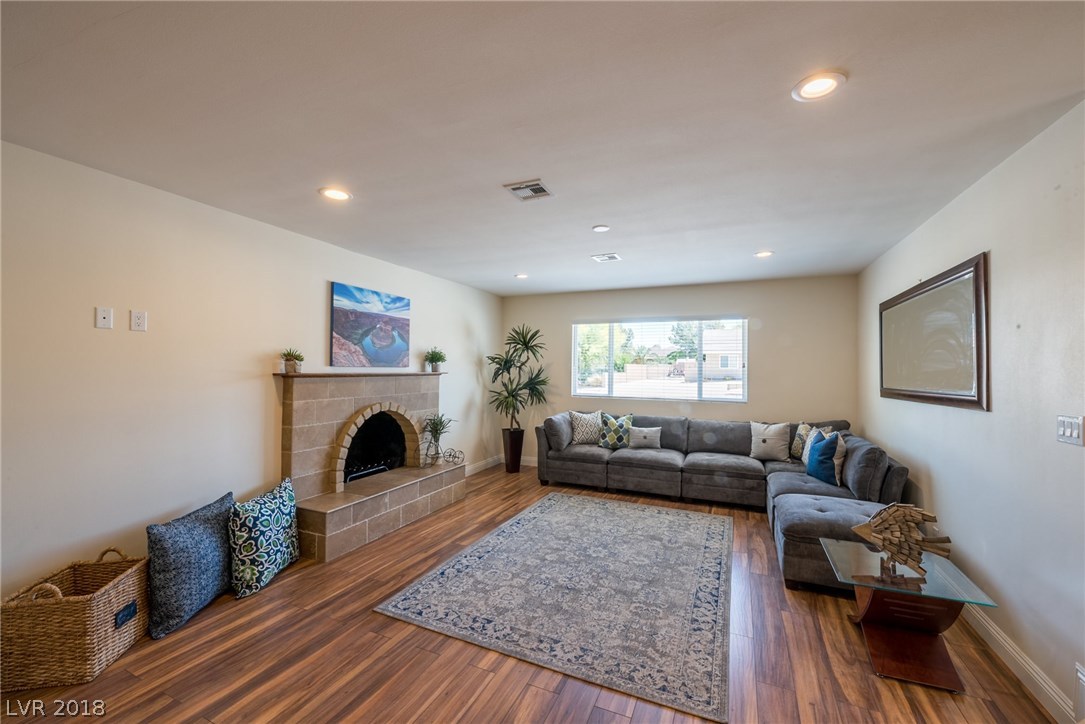 Family room offers a gas fireplace with custom tile surround & mantle.  Large picturesque window overlooks the front yard.  Laminate wood floors add just the right amount of character to this room to feel the comforts of your own home.