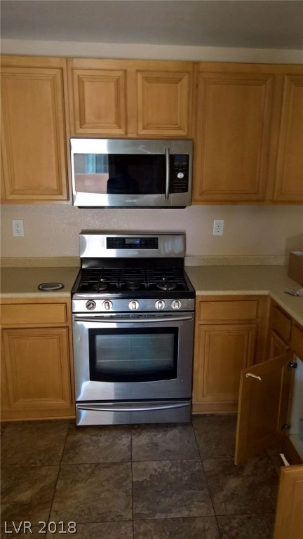 Samsung Gas Range; ceramic tile floors, oak cabinets & solid surface counter top for E-Z cleaning