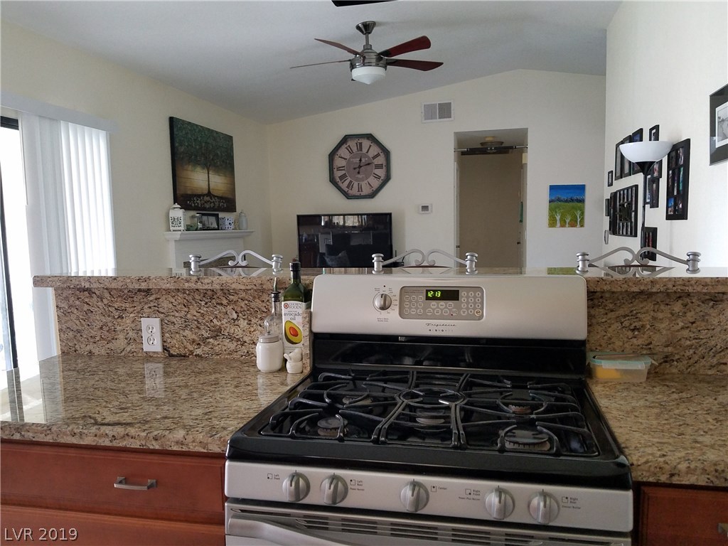Sophisticated 5 burner stove surrounded by more work space and big drawers on both sides.  Overlooks the family room.  So easy to serve the family at the breakfast bar! Or step to the right into the dining room.  Very good floor plan!