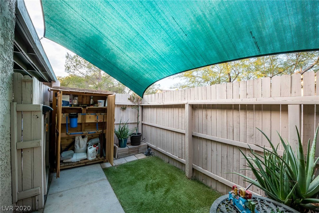 Back patio with synthetic grass.