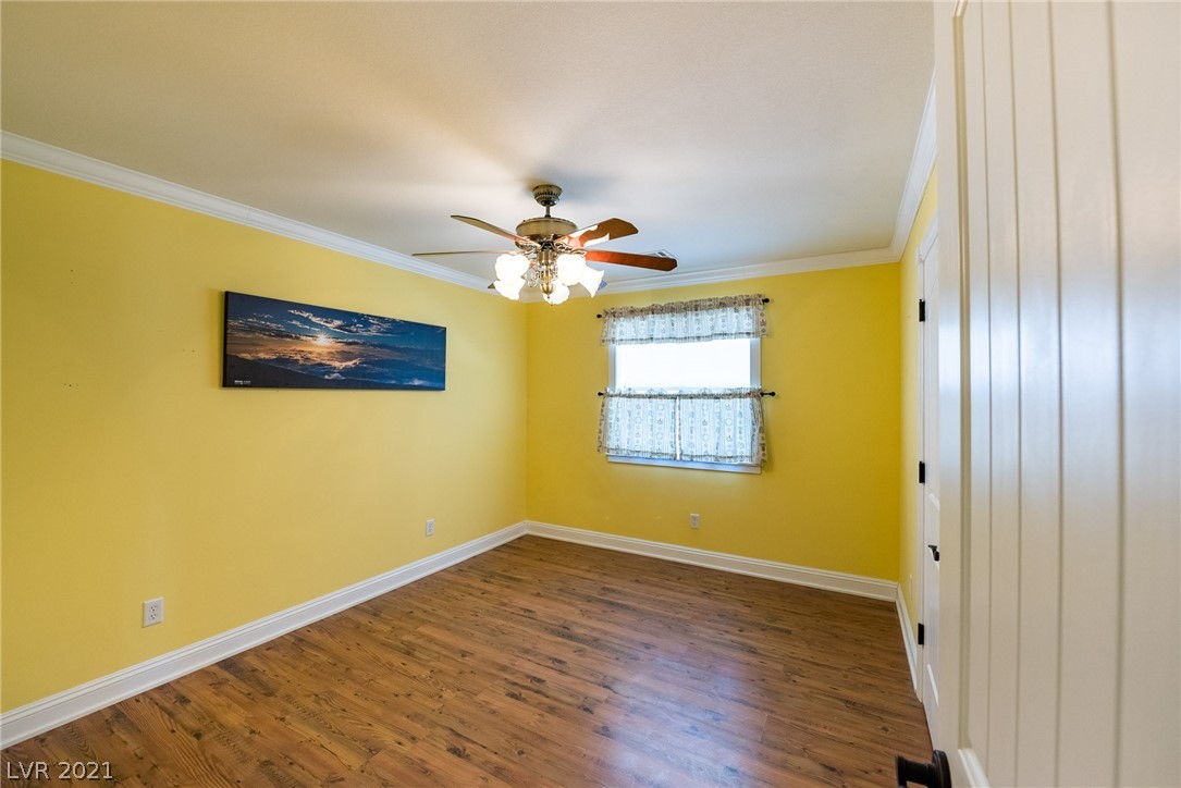 2nd bedrooms offers large closet, laminate floors, ceiling fan, and window with natural light.