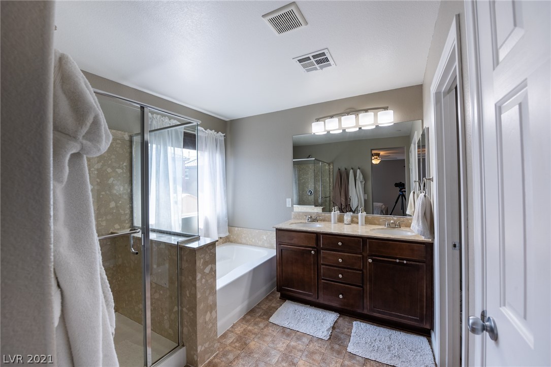 Master bathroom offers double sink raised height vanity + separate stand up shower & large soaking tub.
