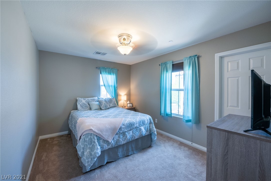 Secondary bedroom offers ceiling fan and lots of natural light along with walk-in closet.