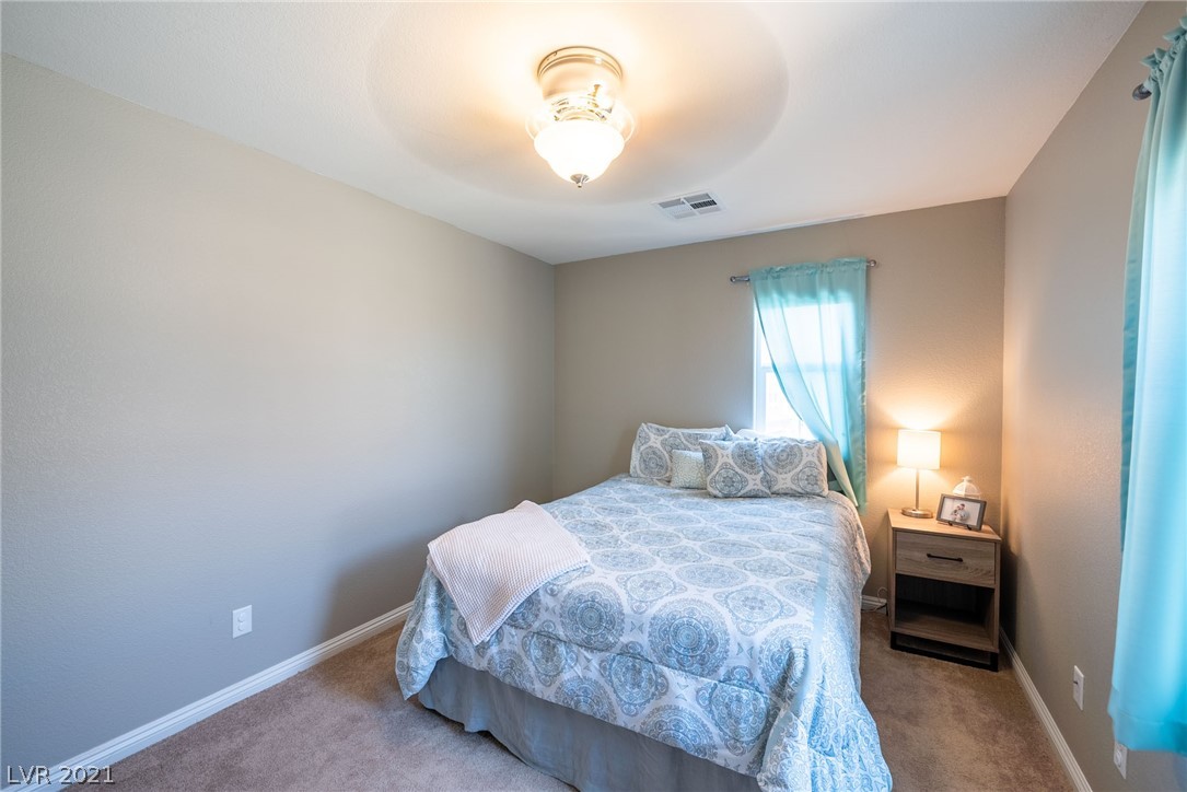 Secondary bedroom is located away from the primary master bedroom.