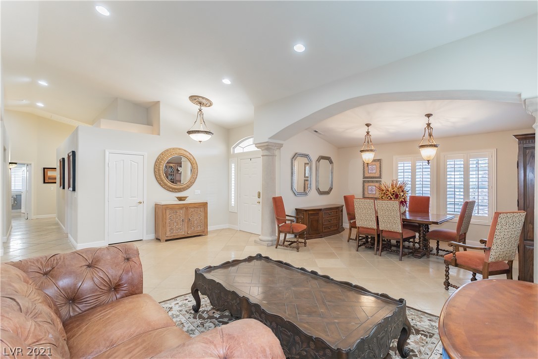 View from the formal entertainment area to wide hallway; Vaulted ceilings give a great deal of height to this open floor plan. Pot shelves to showcase your collectibles!