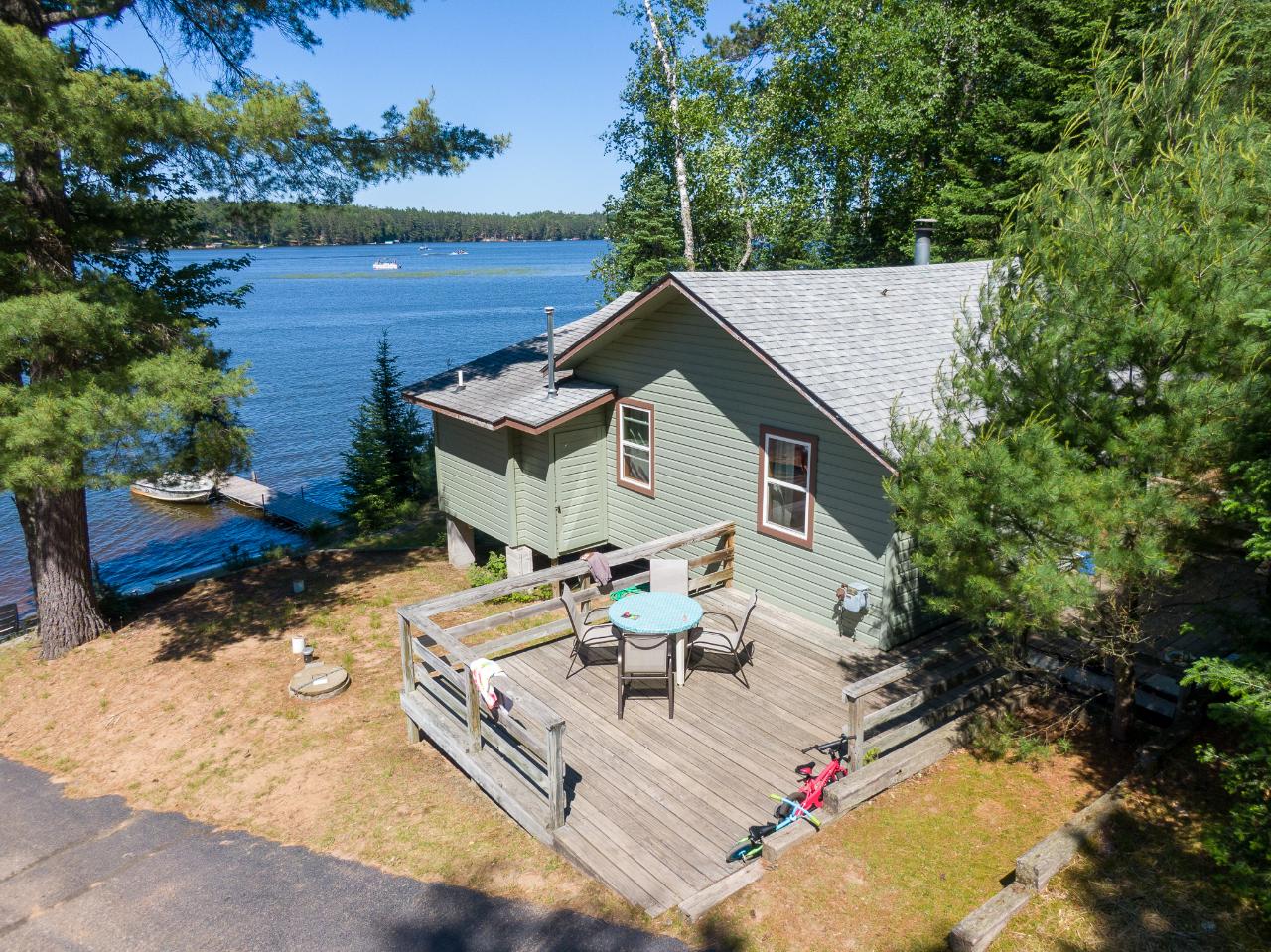 BEAUTIFUL WATERFRONT combined with investment potential in this cute Northwoods cabin! End of the road condo opportunity on Little St. Germain Lake-yet close to shopping, snowmobile trails, and bike trails. Enjoy sandy beaches, private boat launch, docks, swimming area, playground, fish cleaning house, and lakeside storage-all maintained for you! This renovated, fully furnished, seasonal, open concept 2 bedroom, 1 bath cottage includes knotty pine interior, wood burning fireplace, large deck overlooking the lake, and just a couple of steps to the lake. Wooded lot, low traffic, and 800 feet of shared sandy frontage gives a sense of privacy. Association fees include garbage, water filtration, propane, grounds upkeep, and legal fees. Little St. Germain Lake has great fishing and is a Class A Musky Lake. Condo Assoc has Right of First Refusal. There's a lawsuit ongoing with another assoc. member--ask about lis pendens. Buyer to verify all dimensions.