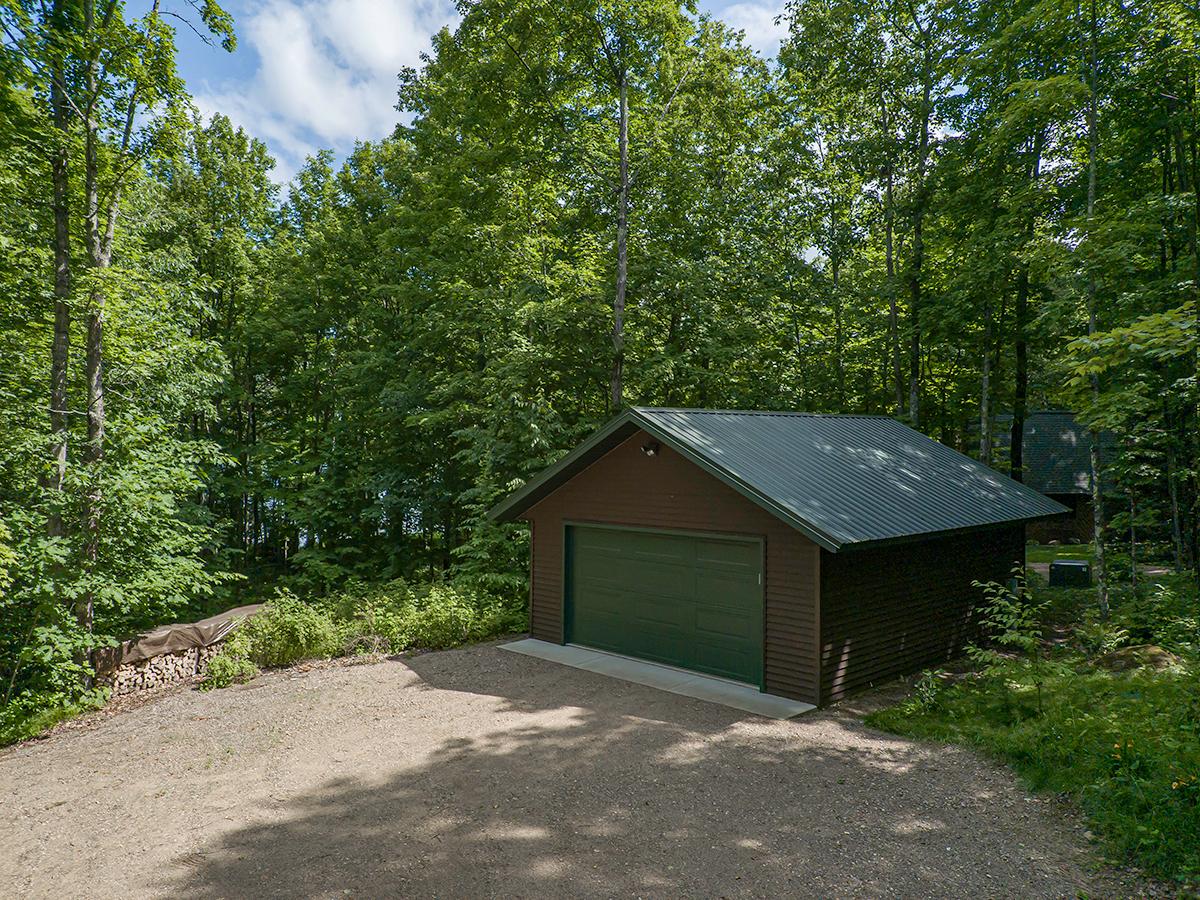 This Enterprise Lake lot is ready for you to build your Northwoods dream home. There is a new gravel driveway, drilled well, and a 20 x 24 2 car garage built in 2015, with power, overhead door and opener, service door, vinyl siding, metal roof, and concrete slab. The 100 feet of frontage has a gentle slope with a level area at the lake. There is sand and some weeds perfect for swimming and fishing. The lot is located on a dead-end road with a beautiful canopy of mature trees on the 1.5-acre lot. Purchase this today and enjoy the rest of summer and fall in the Northwoods. This property is located 21 miles south of Rhinelander and 4 miles west of Elcho for convenient shopping.
