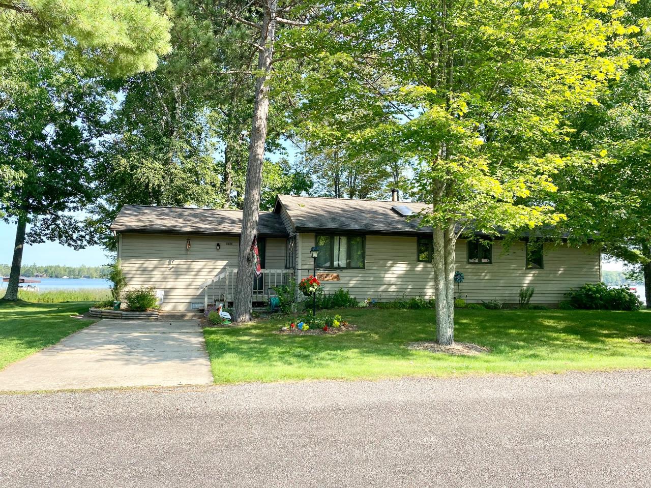 This year-round Pelican Lake house was built in 1986 with six-inch walls and added on in 1995. The lot is level with 100 feet of sand frontage 1.5 acre lot, a detached 2-car garage, a 14 x 20 garden shed, & a 8 x 10 storage shed by the waters edge. The great room has a wood-burning stove, ceiling fan, cathedral cedar ceiling, & cedar walls with large windows on the lakeside. The kitchen is spacious with plenty of cabinets and is open to the dining area. There are 3 bedrooms (two with lakeside windows) and a full bath on one end of the home. The den (spacious guest room) enjoys a lakeside window and the laundry room/ ½ bath is close by. This property comes with furniture, dock, pontoon, & shore station. Pelican Lake has 3585 acres of full recreation water to fish, pontoon, ski & swim, 2 restaurants/bars to boat to, and some of the best lake neighbors you could ask​​‌​​​​‌​​‌‌​‌‌‌​​‌‌​‌‌‌​​‌‌​‌‌‌ for. pontoon, shore station,dock,& furniture included. 2000 gallon holding tank, crawl space access in closet in the laundry room, concrete floor, 2x6 walls