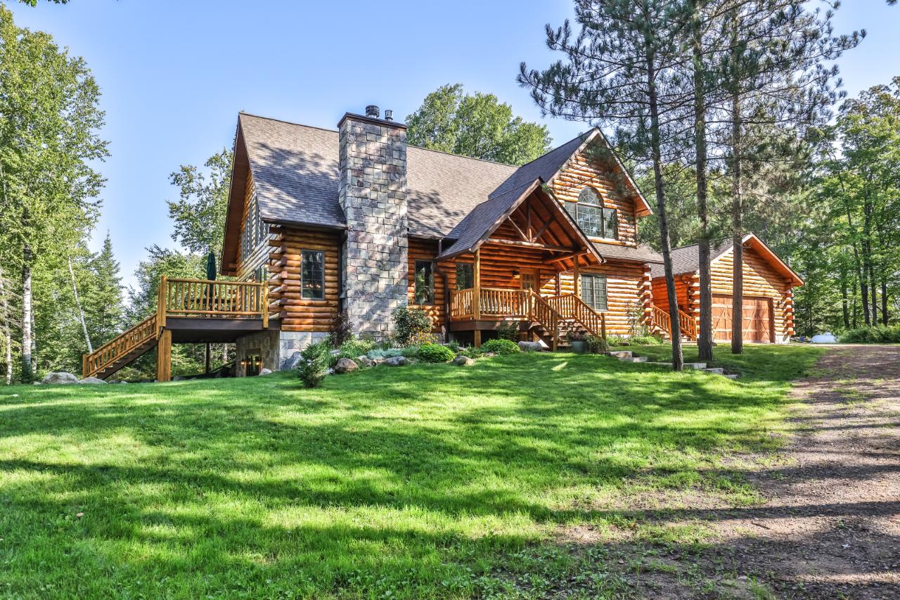This full cedar log home in mint condition was created by the prestigious, Rapid River Log Homes. Standing in the heart of the home you will fall in love w/ the towering cathedral ceilings, full log beams & lakefront wall of glass. Enjoy endless water views on the lake side deck & large screened in porch. Open concept kitchen, dining & living area feat. a breathtaking floor to ceiling fireplace, custom flooring & kitchen w/ high end appliances & granite counter tops. No detail was left behind in the master suite featuring an oversized soaking tub & dream walk in closet. The walkout LL offers a 2nd fireplace, wet bar, theater room & sauna. This 8.3-acre parcel w/ 338’ of frontage offers ultimate privacy backing up to the Catherine Wolter Wilderness Area: 15 wild lakes, 2,641 acres & X country skiing/hiking trail throughout. Oxbow lake is noted for its outstanding fishing & many bays making it one of the most desired lakes in the Northwoods. This elegance & privacy is a very rare find. All measurements are approximate, acreage per Vilas County Tax rolls. Buyer to verify all.