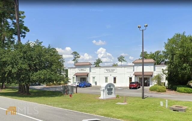 Class A professional office suite offers 2,253 SF with 47 shared parking spaces. Plan contains shared lobby and reception area, 4 private & 5 half-walled offices, conference room, kitchen and one bathroom. The other half of the building is occupied by BHHS Hodnett Cooper Real Estate. High visibility location at lighted intersection and corner of Golden Isles Pkwy & Scranton Rd/Trade St., near mall, FLETC and main corridor for retail shopping. One mile east of I-95 and Exit #38. Base rent $18 psf plus NNN charges. Owner is a licensed real estate broker in the state of Georgia.