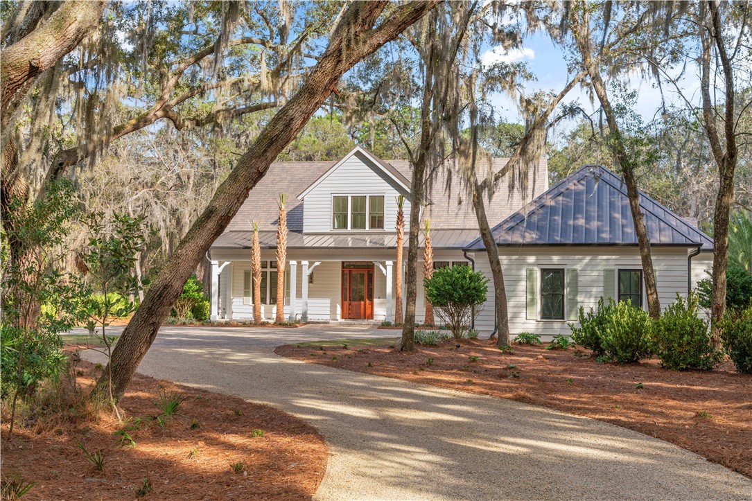 Located on the 4th fairway of the Frederica Golf course, this Lowcountry style home offers a wonderful open living plan with custom touches throughout. The entry with beamed ceiling welcomes you into the grand spaces featuring specialty ceiling treatments and walls of glass bringing the outdoors in. The great room featuring a fireplace and built in cabinetry overlooks the dining room and opens to the kitchen creating seamless spaces for entertaining family or a crowd. The kitchen features a center island, large walk-in pantry, top of the line appliances and opens to the screened porch and overlooks the pool and golf course beyond. A first-floor master retreat with a private patio and study allows for one level living. The back hall offers a gracious laundry room, mudroom, storage, and cabana bath with a breezeway to a 3-car garage. The screened porch offers a fireplace with an adjacent outdoor kitchen with a built-in BBQ grill. The upstairs offers a large family or media room with kitchenette along with three generous guest suites with walk in closets and en-suite baths.
