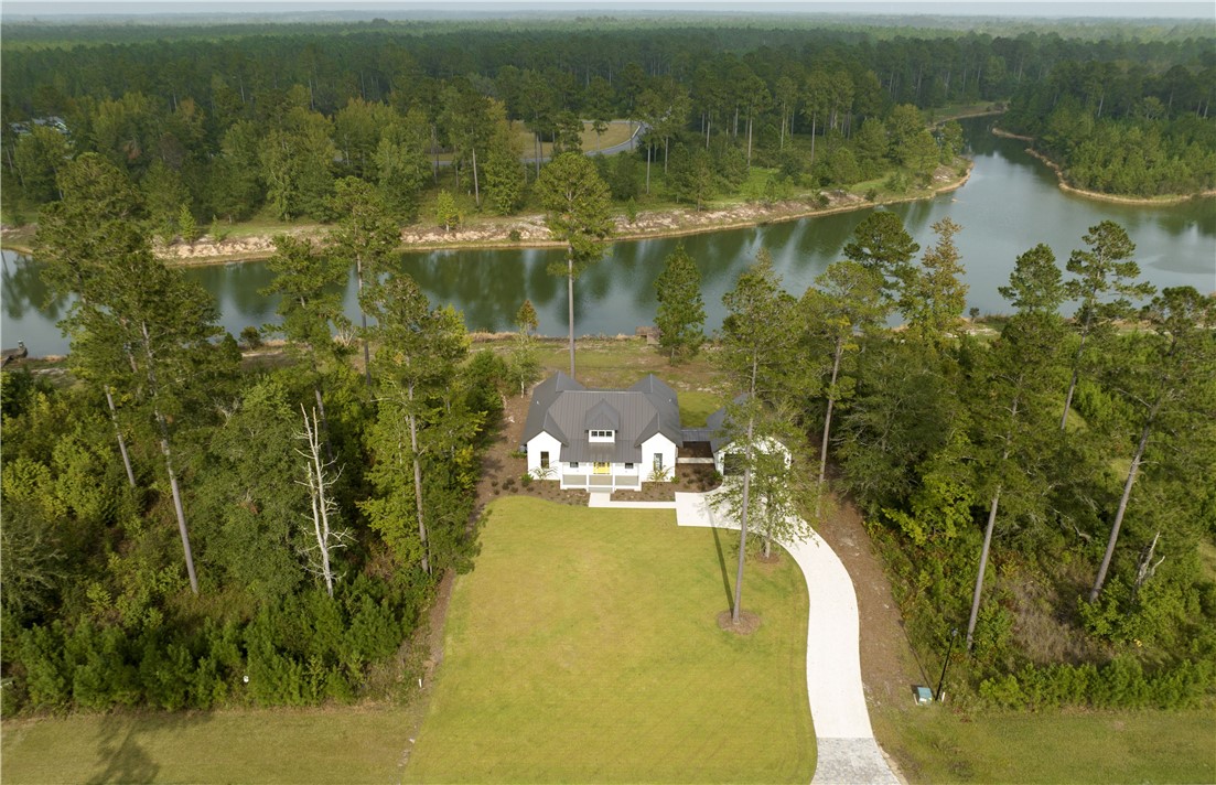 NEW LAKEFRONT HOME WITH PRIVATE DOCK!! Construction is complete on this Sapelo Cottage, custom designed by Wiregrass Studio and built by Coastal Cottage Builders. This beautifully finished, ONE-LEVEL, 3-bedroom, 3 full-bath home features an open-concept floor plan, trendy brown Jeldwyn windows, 10ft+ ceilings throughout, hardwood flooring and tiled baths. Other features include 8' solid core interior doors, brushed gold plumbing and lighting fixtures, KitchenAid stainless appliances, quartz countertops. and spray foam insulation. See documents for all features. Recently converted to X-zone - NO FLOOD - certificate in documents. This neighborhood is a NATURE LOVER'S DREAM! Chill in the zero-entry community pool overlooking acres of lakes and wildlife, spend the day kayaking on the lake or relax by the fireplace at the community clubhouse. Lakeside has deep water access on the Little Satilla with a community dock, boat launch and storage, projected completion summer 2023. Easy access to I-95, shopping, restaurants and schools. The beach is only a 20-minute drive away. Gate code needed for entry. Floorplan in photos is for general purposes only.