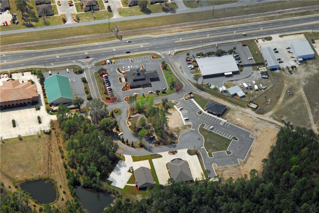 This parcel is located in Satilla Office Park with established parking, sidewalks, and green space. It combines three smaller lots, each pad ready, designed for three 7,600 sf buildings which could be combined for a larger singular building.  The parcel also includes a driveway for dumpster, more parking or reconfiguring for additional building. Water, sewer, and electricity are available on site.  Centrally located near Hwy 40 and Kings Bay Road intersection near Walmart & the hospital, positioned behind Synovus Bank with Hawthorne Lane entering on the east side of the bank. Owner will consider subdividing or Build-to-Suit. Call to discuss the many possibilities.