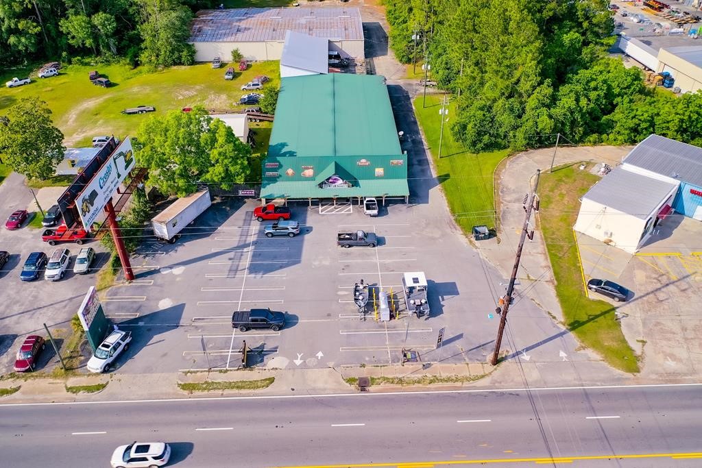 Amazing opportunity to purchase over 20,040+/- sf of building space situated on 2.44+/- acres with Hwy frontage on Memorial Dr, which produces very high traffic volumes daily from being located in the middle of all major shopping and dining in Waycross. This business is currently known as Eagle Pawn Outfitters which has been in business for over 41 years, leaving its mark on the local community and the surrounding areas of Southeast Georgia. The retail space at the front of the property features a large open showroom floor and office spaces which consist of 5,040+/- sf. The building in the back of the property is a large fenced in 15,000+/- sf metal warehouse with concrete floors, offering an abundance of storage space. Note that the offering is for real estate only. The business can be sold separately fo an additional price. Again, this is a prime location in Waycross with endless opportunities, call today for more info!