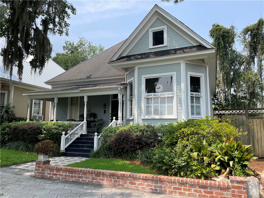 This Historic Old Town cottage is tucked into its setting along Union Street just steps from the downtown vibe.  This 1-story Victorian cottage built in 1910 has incredible 12' ceilings that feel SO spacious.  Original six panel wood doors, transom windows, bead board, picture rails, beautiful vintage light fixtures, just to name a few historic details. You are in easy walking distance to all the downtown restaurants, historic parks, music venues, library and waterfront. All the best architectural features indicative of a turn of the century home lives very comfortably with two generous size bedrooms and two bathrooms.  The sunroom toward the rear of the house offers an area for a home office, if desired. There is plenty of room for the placement of an island in the kitchen or an eat-in cafe table and chairs. There is a little nook designed for afternoon calmatives or beverage service too. The  heart pine floors are truly beautiful in every room.  While the yard space is minimal, it has been designed for outdoor living enjoyment with enough planting area to satisfy your horticultural exploits.  Carefree living! The rear patio area and landscaped garden offers a terrific opportunity to entertain friends and relax at the end of a day.  There is also a detached workshop and shed. Permanent angled walk up stairs to second floor offers possible opportunity for expanded living space. Owner has provided a history of all the improvements and restoration completed on the property during their ownership.