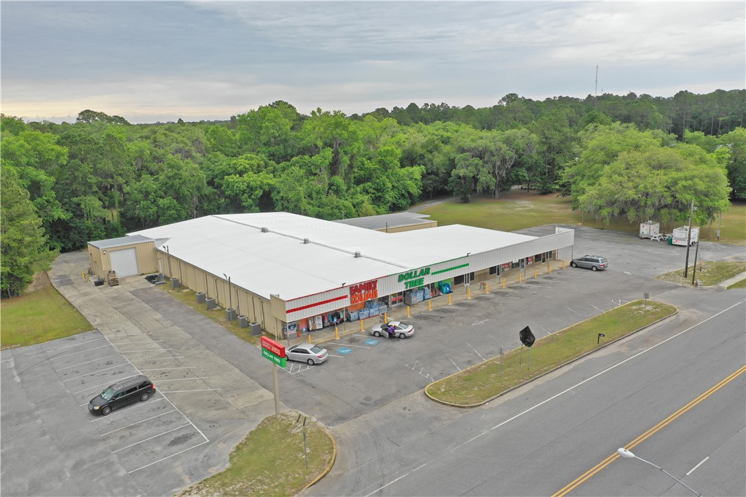 Here is an incredible opportunity to own a high-producing commercial property located on one of the busiest intersections in McIntosh County. This almost 24,000 square-foot building sitting on 3.94 Acres has a successful long-term lease tenant (Family Dollar/ Dollar Tree) in place as well as four other rental spaces, 3 of which are month-to-month and Could be reimagined to combine into one larger space for an additional franchise. The property is located just 1 mile from the interstate as well as the historic Darien waterfront. Other unique features about this property are that it has a drive-through as well as 1.6 acres of green space that could be built on for expansion as well as two billboards facing an extremely busy intersection that brings in great monthly income.