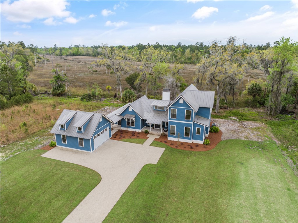 QUALITY NEW CONSTRUCTION ON THE MARSH!! NOT YOUR USUAL SPEC HOME!! Construction is complete on this gorgeous home, custom designed by Wiregrass Studio and built by Coastal Cottage Builders. This beautifully finished, 4 bedroom/3.5 bath home features an open-concept floor plan, Jeldwyn insulated windows, 10ft. ceilings, solid core interior doors, hardwood flooring and tiled baths. Other features include, brushed gold plumbing and lighting fixtures, KitchenAid stainless appliances, quartz countertops, gas range and fireplace and spray foam insulation. Extensive landscaping on this large lot. See documents for all features. This neighborhood is a NATURE LOVER'S DREAM! Chill in the zero-entry community pool overlooking acres of lakes and wildlife, spend the day kayaking on the lake or relax by the fireplace at the community clubhouse. Lakeside has deep water access on the Little Satilla with a community dock, boat launch and storage, projected completion fall 2023. Easy access to I-95, shopping, restaurants and schools. The beach is only a 20-minute drive away. Gate code needed for entry. Floorplan in photos is for general purposes only. The developer and builder reserve the right to make changes to the plan during construction.