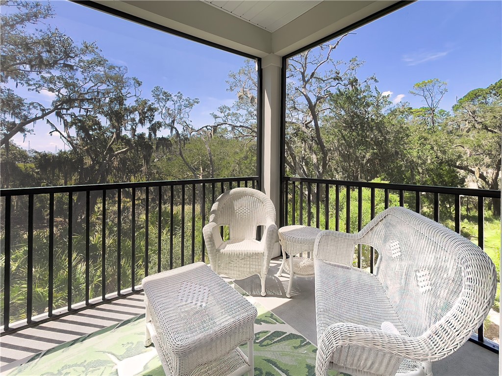 Beautifully furnished, this newly constructed condominium complex with resort style pool located in the heart of Jekyll Island, sold out completely before they were even finished! With westerly breezes and river and marsh facing views through a canopy of stunning Live Oak trees from the Master, the Living Room and the private Screened Porch, this 3 BR/3 BA home is ready for its new owners to gather each evening for sunset views. Large master bedroom, bathroom and closets make this perfect for full timers and part timers alike. Elevator, covered under building parking, large pool and clubhouse are fantastic amenities. You can see the tops of the sailboats moored at The Jekyll Harbor Marina and walk to Zachary's for dinner in just a few short steps for your own neighborhood restaurant. Easy, protected walking to both the Jekyll Island Club Resort (1 mile) and the Village/Convention Center (1/2 mile). With the amazing number of bike paths throughout Jekyll, you can park and never use your car again.
